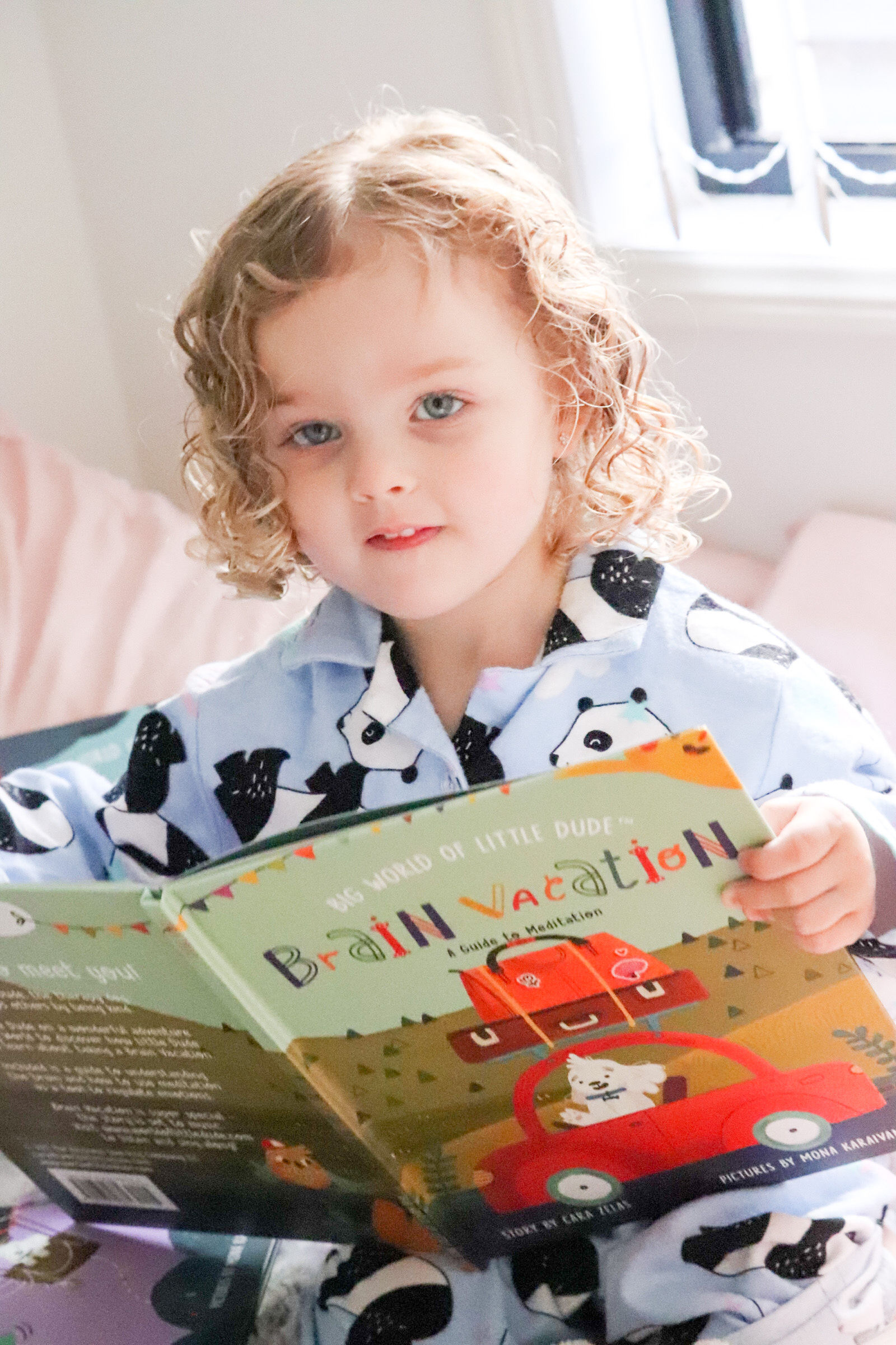 Child reading Big World of Little Dude