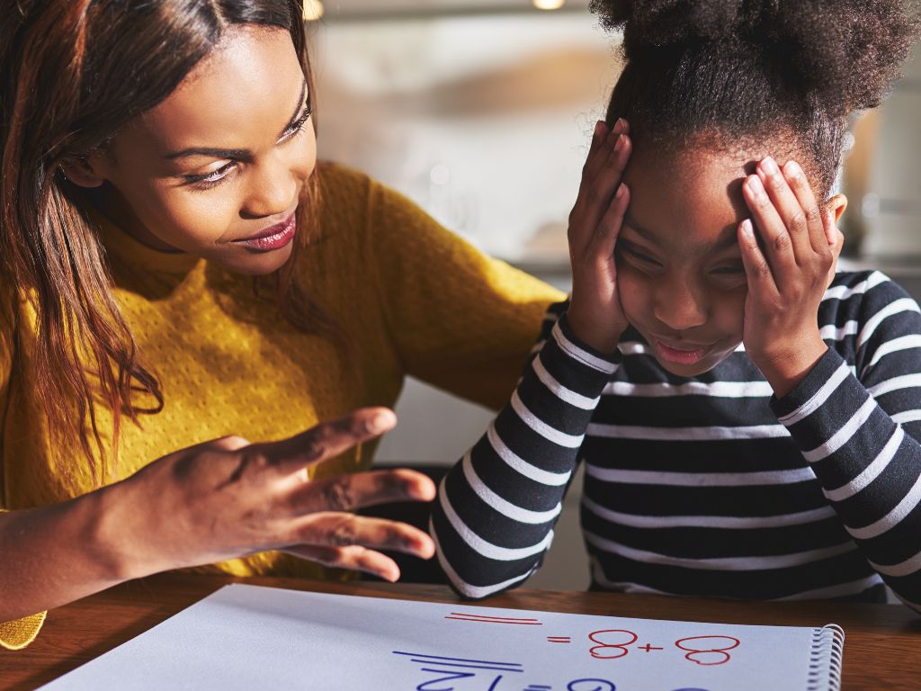  Child learning to manage emotions with adult support during a moment of frustration
